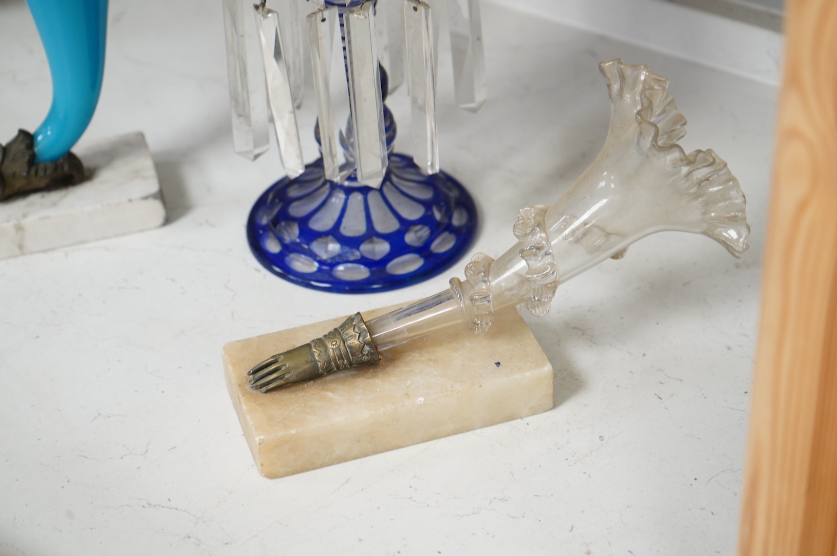 A late 19th century blue overlay glass table lustre and two late 19th century cornucopia shaped glass and brass mounted vases on stands